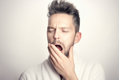man yawning after a night of drinking