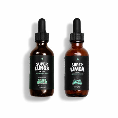 Two amber glass dropper bottles: Super Lungs and Super Liver.